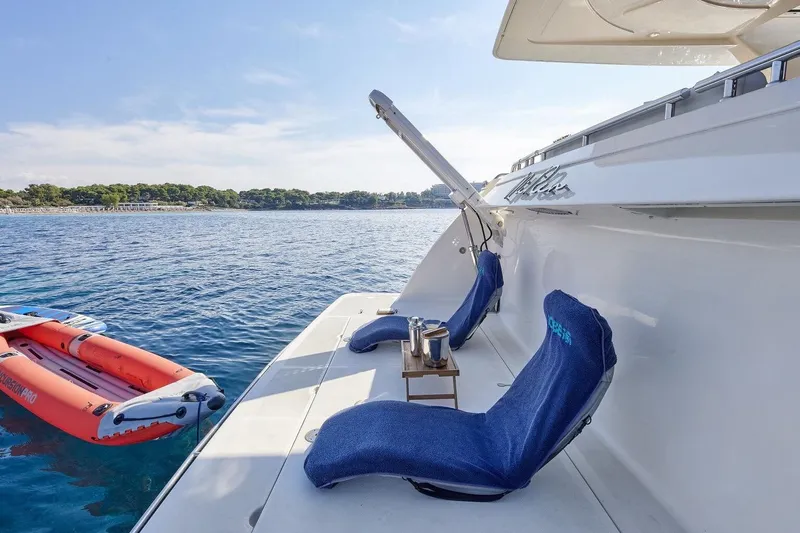 Miren Yacht Photos Pics Luxury Ferretti Yachts 68, 2000 model, with deck chairs and inflatable boat on serene water.