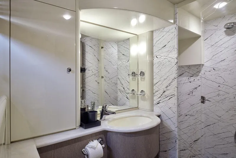 Miren Yacht Photos Pics Luxurious bathroom in 2000 Ferretti Yachts 68, featuring elegant marble walls and modern fixtures.