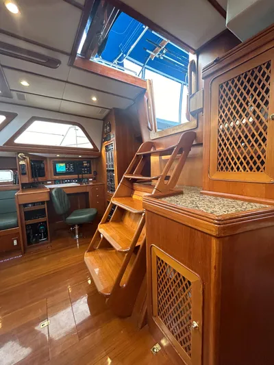 Voodoo Yacht Photos Pics Luxurious interior of a 2010 Hylas 70 yacht with wooden finishes and modern navigation equipment.