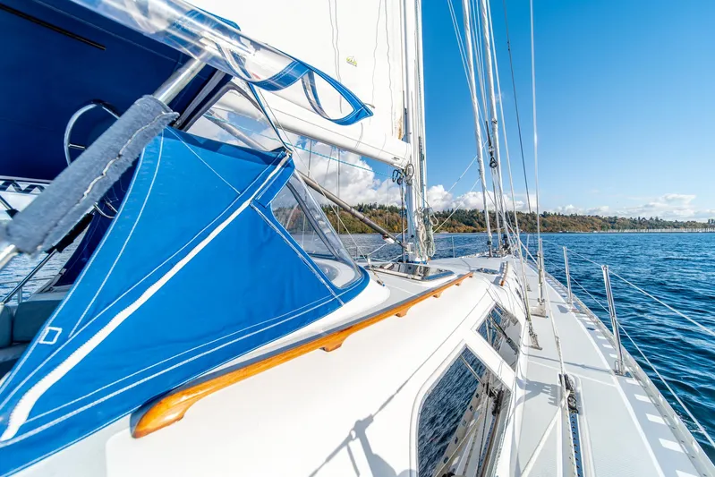 Voodoo Yacht Photos Pics Sailing on a 2010 Hylas 70 yacht with blue canopy, clear skies, and calm waters.