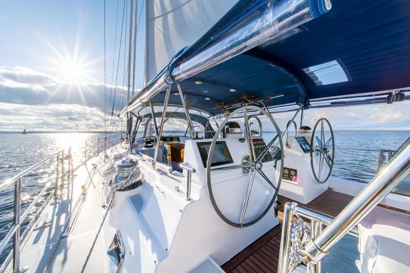 Voodoo Yacht Photos Pics Luxurious 2010 Hylas 70 yacht sailing on open water at sunset.