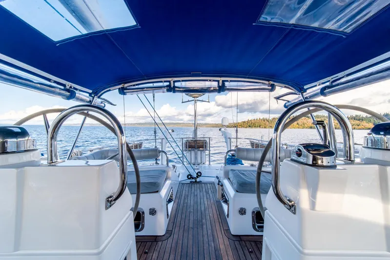 Voodoo Yacht Photos Pics Luxury Hylas 70 yacht interior with blue canopy, dual steering wheels, and scenic ocean view.