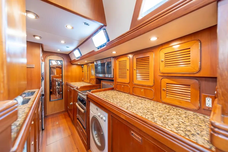 Voodoo Yacht Photos Pics Luxurious wooden interior of 2010 Hylas 70 yacht kitchen with granite countertops.