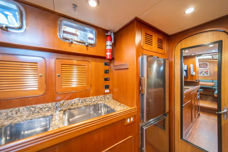 Voodoo Yacht Photos Pics Luxurious Hylas 70 yacht interior with wooden cabinetry, granite countertops, and stainless steel appliances, 2010 model.