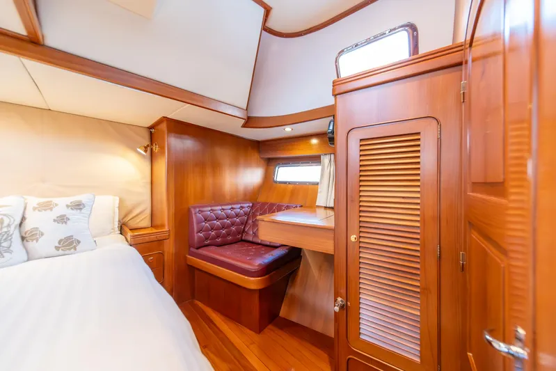 Voodoo Yacht Photos Pics Luxurious cabin interior of a 2010 Hylas 70 yacht with wood finishes and cozy seating.