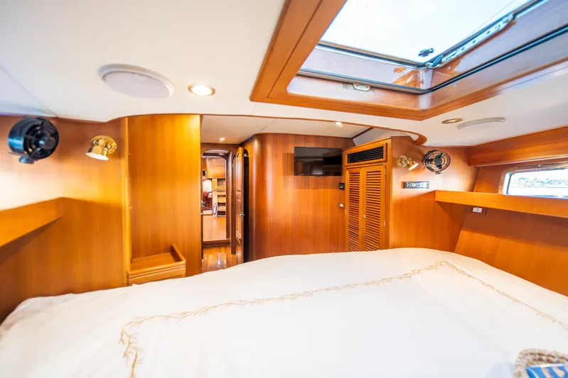 Voodoo Yacht Photos Pics Luxurious cabin interior of a 2010 Hylas 70 yacht with wood paneling and skylight.