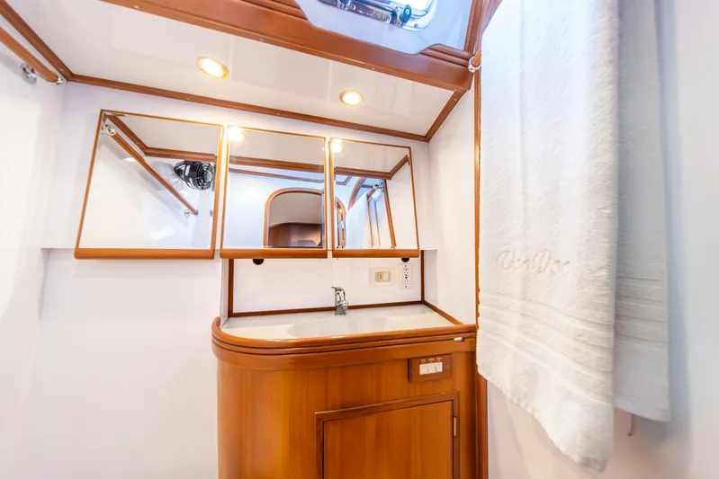 Voodoo Yacht Photos Pics Luxurious bathroom interior of 2010 Hylas 70 yacht with wooden cabinetry and mirrors.