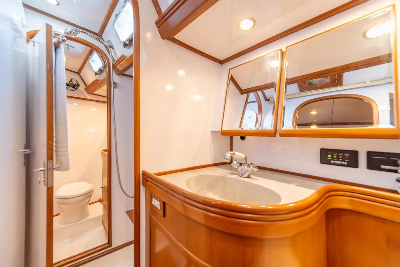 Voodoo Yacht Photos Pics Luxurious bathroom interior of 2010 Hylas 70 yacht with wooden accents and modern fixtures.