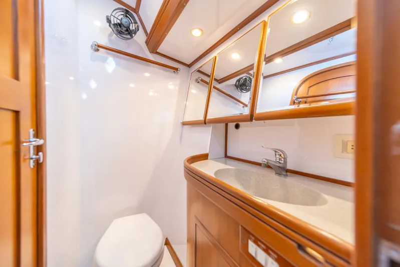 Voodoo Yacht Photos Pics Luxurious bathroom in 2010 Hylas 70 yacht with wooden cabinetry and modern fixtures.