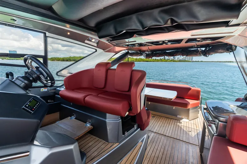 Damare Yacht Photos Pics Interior of 2022 Cranchi M 44 HT yacht with red seating and scenic water view.