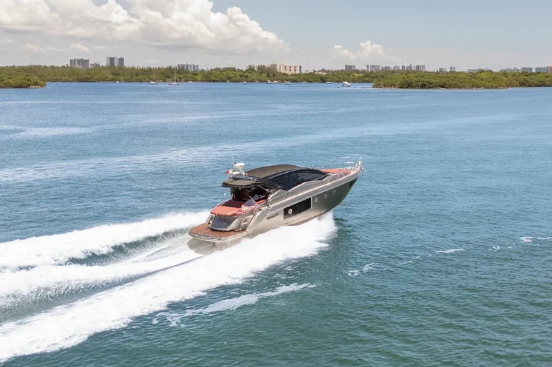 Damare Yacht Photos Pics 2022 Cranchi M 44 HT yacht cruising on open water under a clear sky.