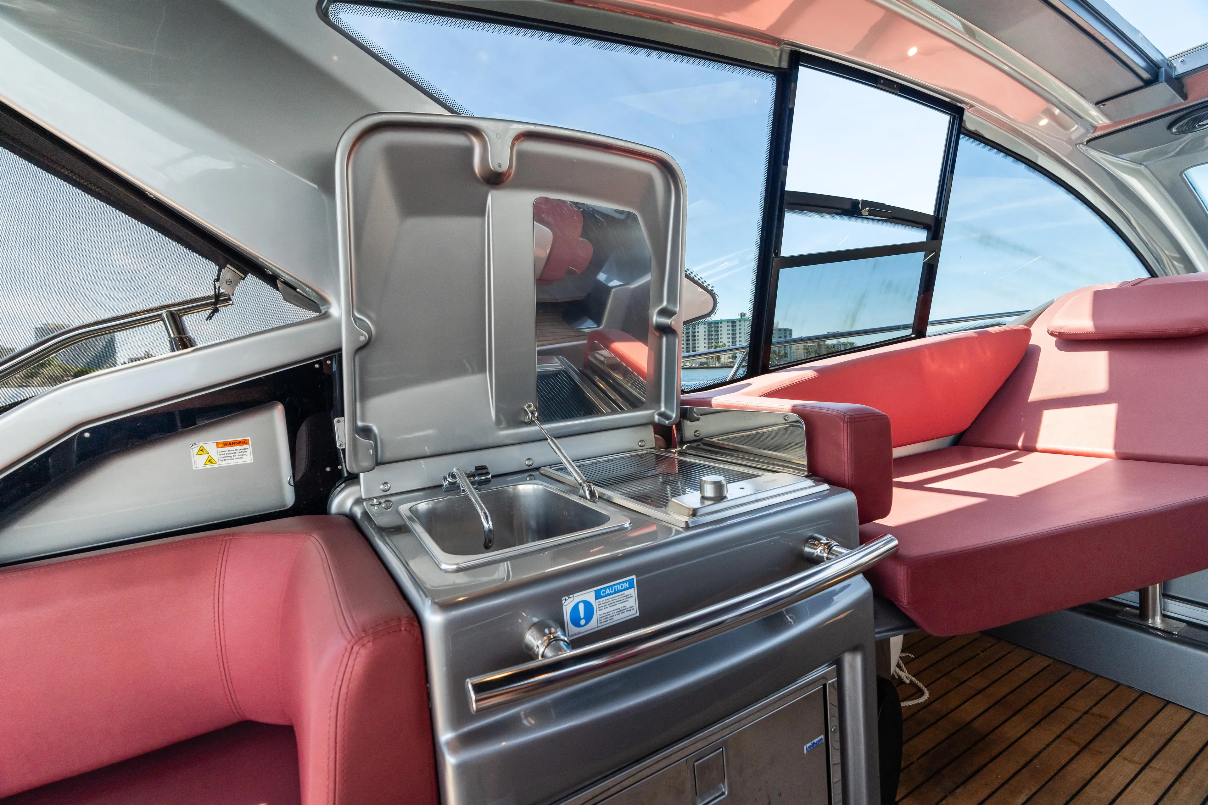 Damare Yacht Photos Pics Luxurious 2022 Cranchi M 44 HT yacht interior with kitchenette and red seating.