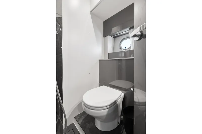 Damare Yacht Photos Pics Modern bathroom in 2022 Cranchi M 44 HT yacht with sleek design and porthole window.