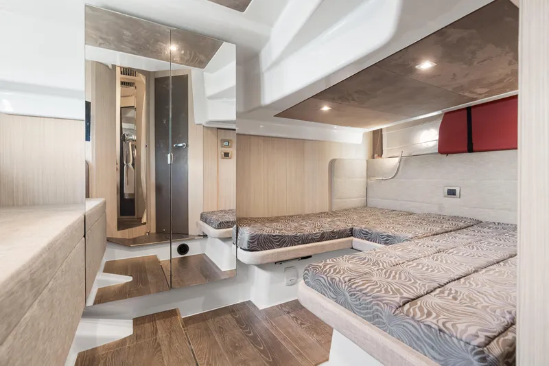 Damare Yacht Photos Pics Interior of 2022 Cranchi M 44 HT yacht with modern twin beds and elegant wood finishes.