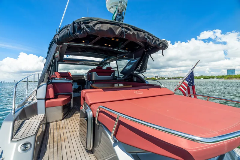 Damare Yacht Photos Pics 2022 Cranchi M 44 HT yacht with red seating, docked on a sunny day.