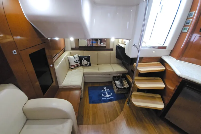  Yacht Photos Pics Luxurious interior of 2008 Sea Ray 40 Sundancer yacht with cozy seating and elegant wood finishes.