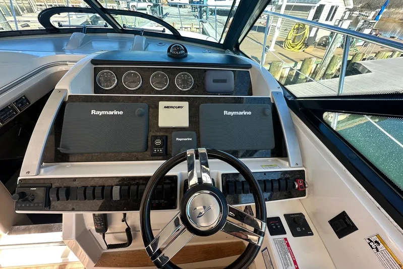  Yacht Photos Pics Cockpit of 2014 Sea Ray 410 Sundancer with Raymarine navigation system and steering wheel.