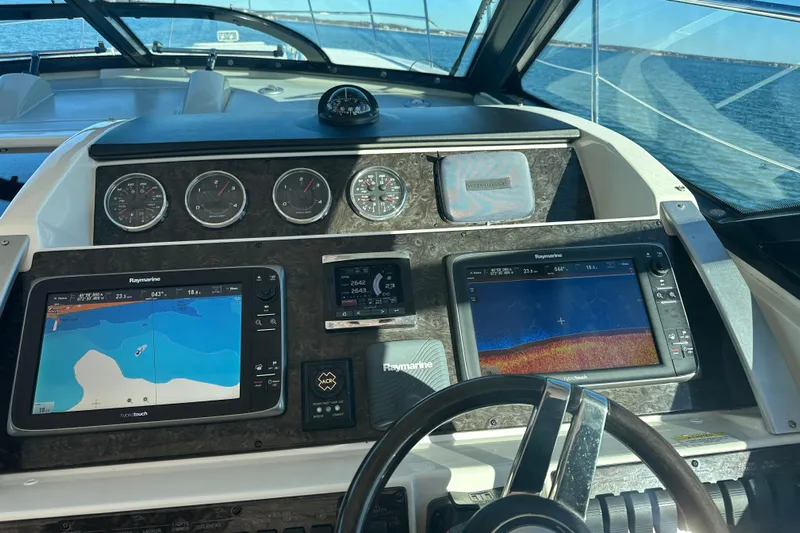  Yacht Photos Pics Cockpit of 2014 Sea Ray 410 Sundancer with navigation displays and steering wheel.
