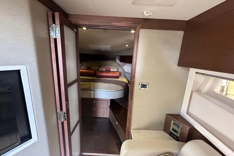  Yacht Photos Pics Interior of 2014 Sea Ray 410 Sundancer yacht, featuring cozy bedroom and modern design.