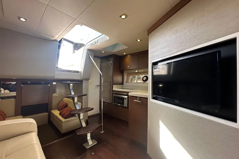  Yacht Photos Pics Luxurious interior of 2014 Sea Ray 410 Sundancer yacht with modern kitchen and seating area.