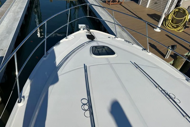  Yacht Photos Pics 2014 Sea Ray 410 Sundancer boat docked, showing bow deck and railing.