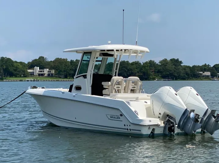 Patriot Yacht Photos Pics 2020 Boston Whaler 250 R boat with dual engines on a calm lake.