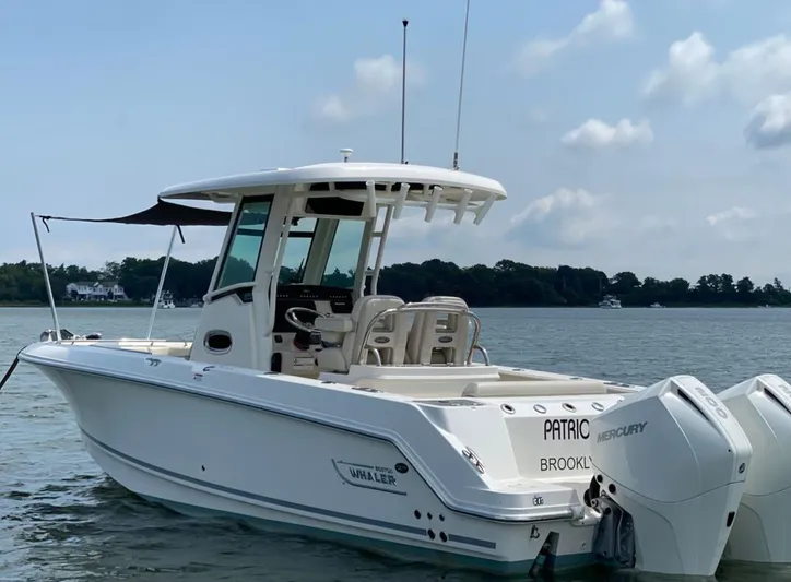 Patriot Yacht Photos Pics 2020 Boston Whaler 250 R boat on calm water with twin Mercury engines.