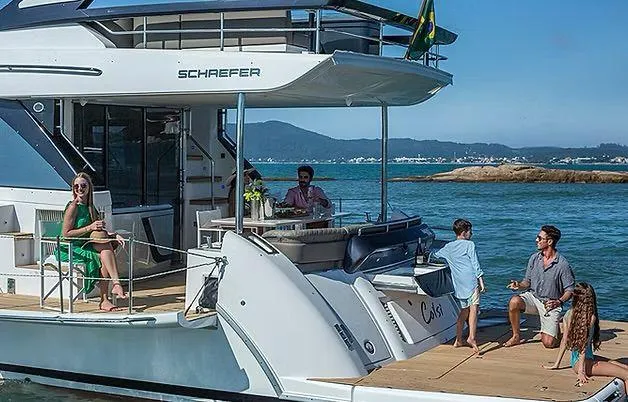  Yacht Photos Pics Luxury Schaefer 600 yacht with people enjoying a sunny day on the water, 2026 model.