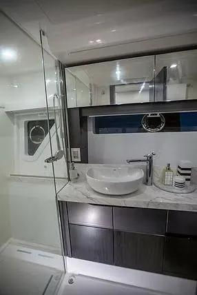  Yacht Photos Pics Luxurious bathroom in 2026 Schaefer 600 yacht with modern fixtures and elegant design.