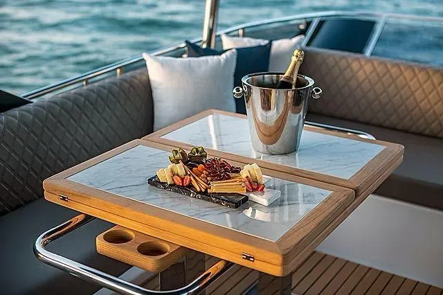  Yacht Photos Pics Luxurious Schaefer 600 yacht interior with champagne and charcuterie on a stylish table.