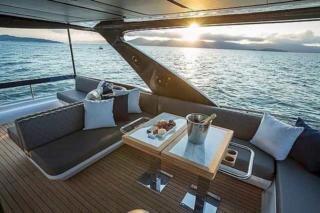  Yacht Photos Pics Luxurious Schaefer 600 yacht interior with sunset view, featuring elegant seating and dining setup.