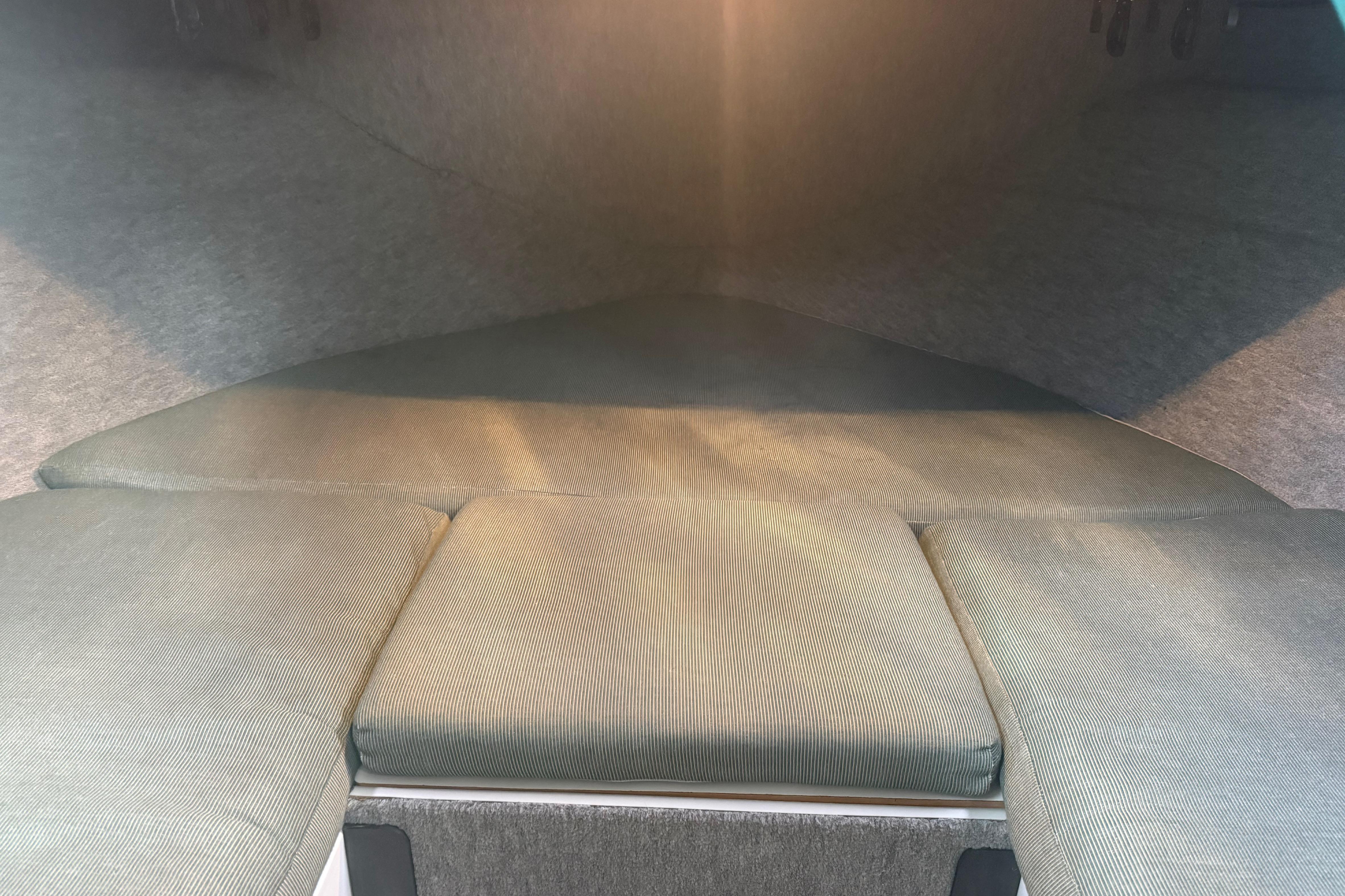 Interior cabin of a 1998 Davis Rock Harbor 25 boat, featuring cushioned seating.