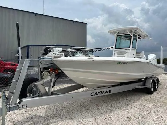 Caymas 28 Hb Twin Yacht Photos Pics 2022 Caymas 28 Twin boat on trailer, parked outdoors near a building.