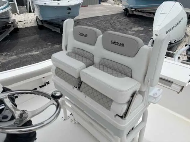 Caymas 28 Hb Twin Yacht Photos Pics 2022 Caymas 28 Twin boat interior with dual cushioned seats and steering wheel.