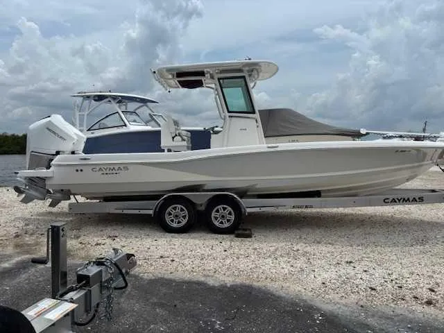 Caymas 28 Hb Twin Yacht Photos Pics 2022 Caymas 28 Twin boat on trailer, parked outdoors under cloudy sky.