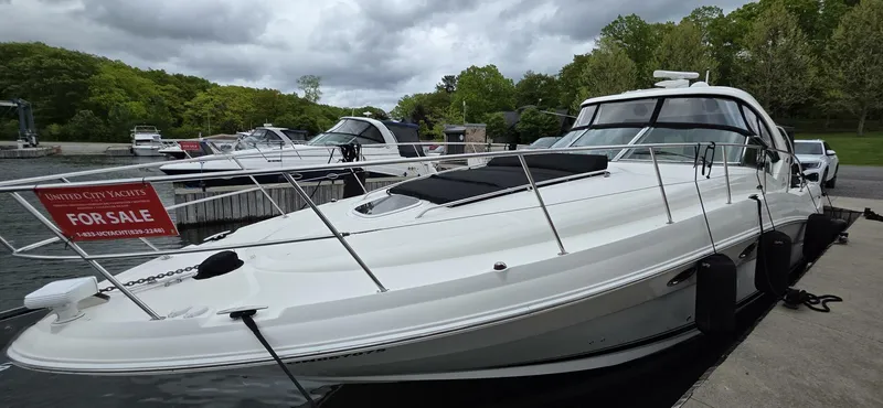  Yacht Photos Pics 2005 Sea Ray 40 Sundancer yacht docked, for sale, with lush greenery in the background.