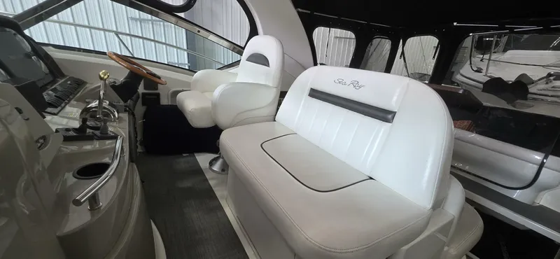  Yacht Photos Pics 2005 Sea Ray 40 Sundancer interior with white leather seating and helm controls.