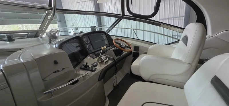  Yacht Photos Pics 2005 Sea Ray 40 Sundancer helm with modern controls and luxurious white seating.