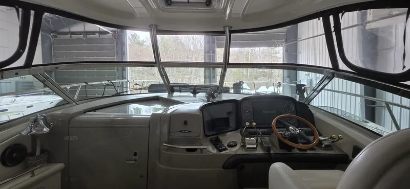  Yacht Photos Pics Interior view of 2005 Sea Ray 40 Sundancer yacht cockpit with steering wheel and controls.