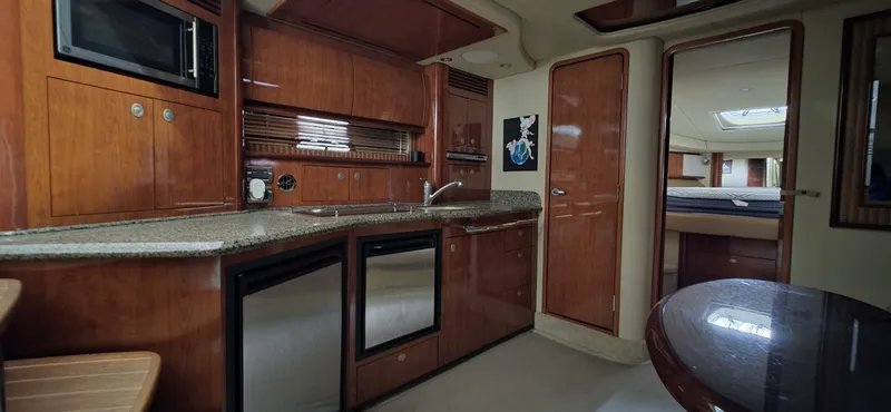  Yacht Photos Pics Interior of 2005 Sea Ray 40 Sundancer yacht with modern kitchen and wood finishes.