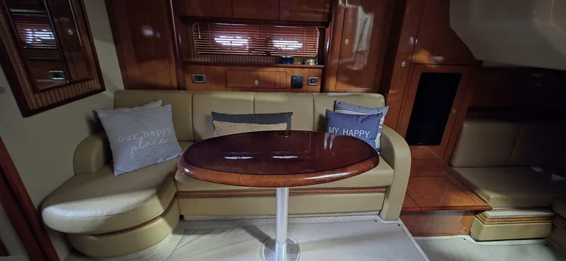 Yacht Photos Pics Interior of 2005 Sea Ray 40 Sundancer with cozy seating and wooden table.