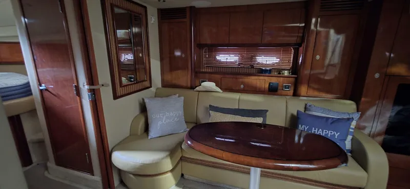 Yacht Photos Pics Interior of 2005 Sea Ray 40 Sundancer yacht with cozy seating and wooden accents.