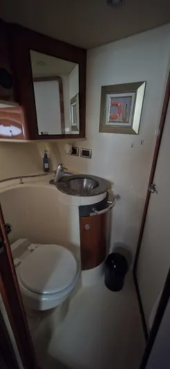  Yacht Photos Pics 2005 Sea Ray 40 Sundancer bathroom with sink, toilet, and wall art.