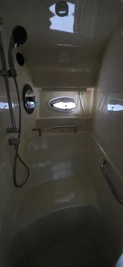  Yacht Photos Pics Interior shower of 2005 Sea Ray 40 Sundancer yacht with porthole and chrome fixtures.