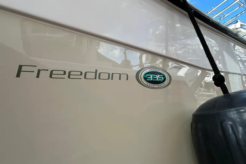  Yacht Photos Pics 2013 Grady-White Freedom 335 boat side view with logo and fender.