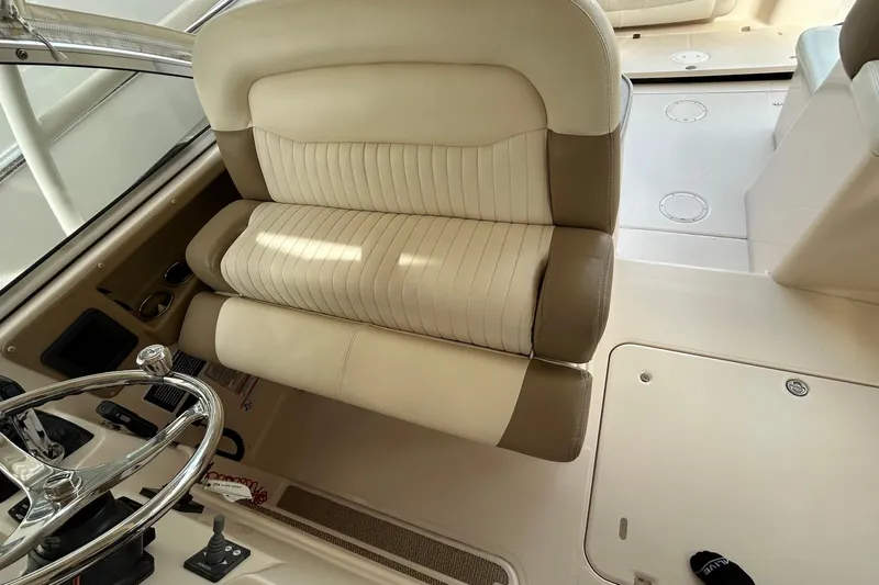  Yacht Photos Pics 2013 Grady-White Freedom 335 boat interior with beige seating and steering wheel.