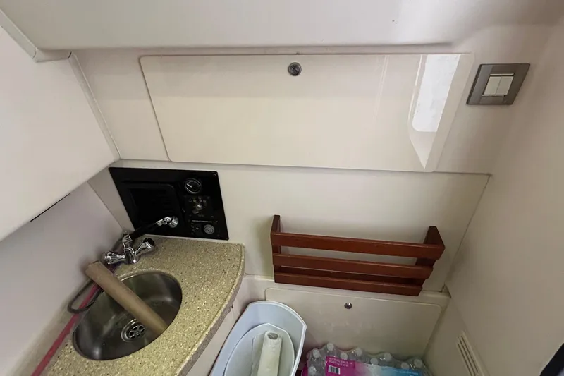  Yacht Photos Pics 2013 Grady-White Freedom 335 boat interior with sink and storage area.