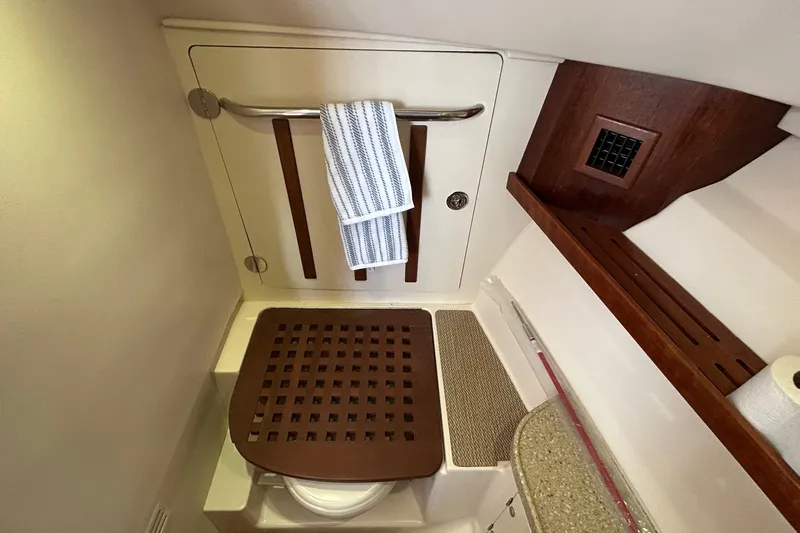  Yacht Photos Pics 2013 Grady-White Freedom 335 boat bathroom with wooden accents and towel rack.