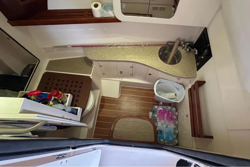  Yacht Photos Pics Interior of 2013 Grady-White Freedom 335 boat, featuring compact amenities and storage.