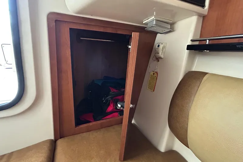  Yacht Photos Pics 2013 Grady-White Freedom 335 interior storage compartment with open wooden door.